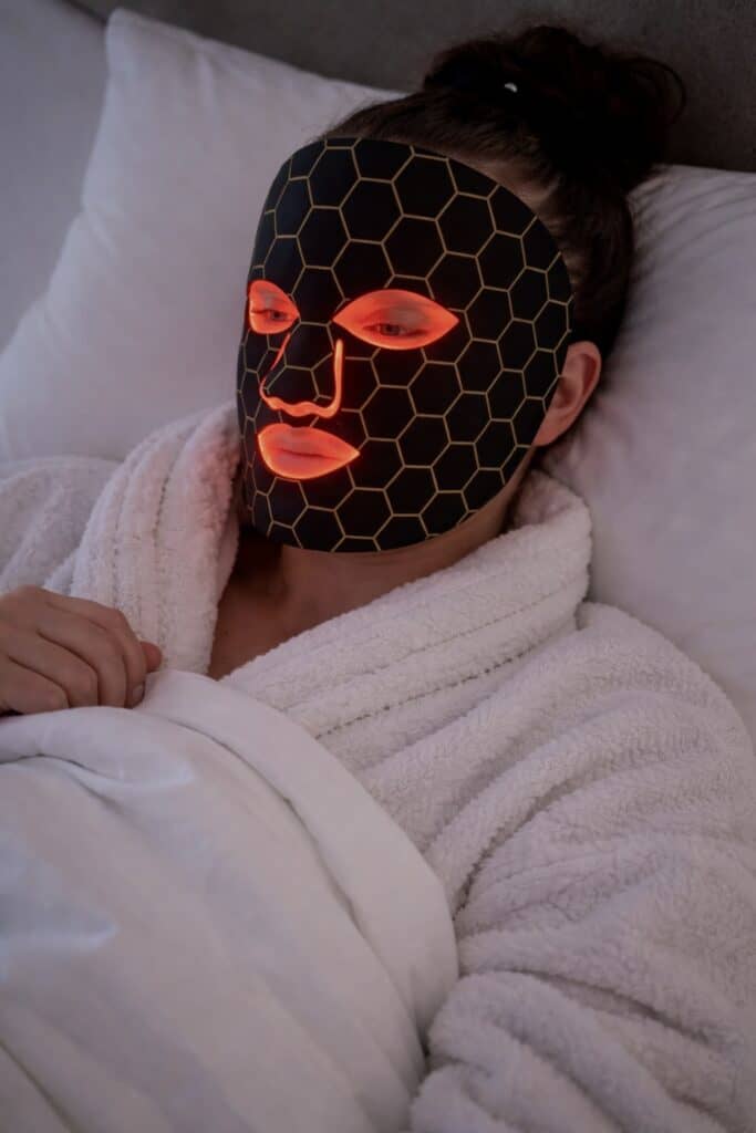 using LED light therapy mask at home evening skincare routine relaxed setting